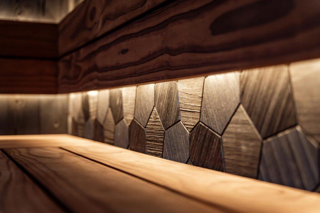 Interior of a modern infrared sauna with warm wooden paneling and LED accent lighting, premium spa setting
