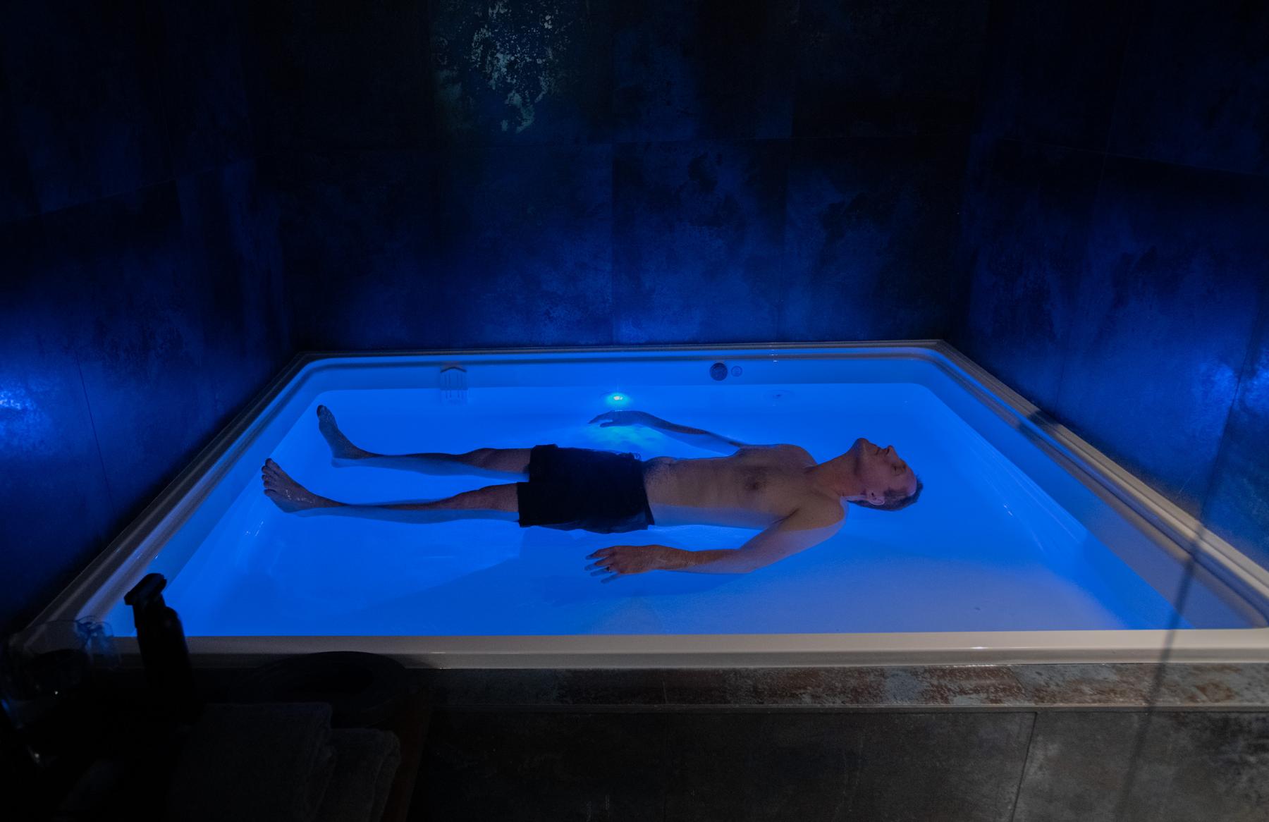 Man floating in open pool